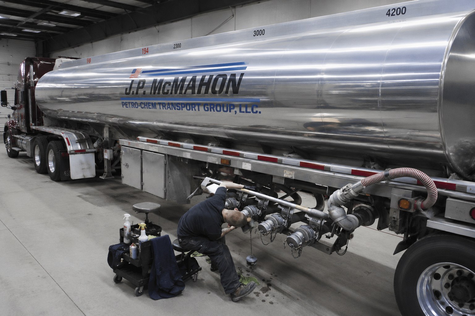 J.P. McMahon driver carefully servicing tanker valves